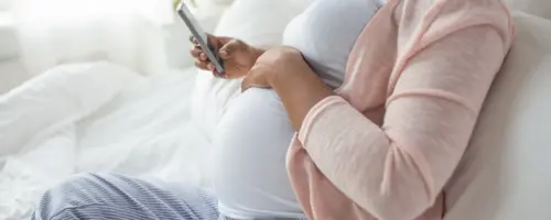 Pregnant woman on the phone with social worker